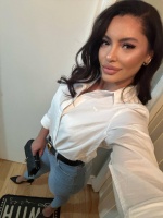 Kylie wearing jeans and a white shirt 